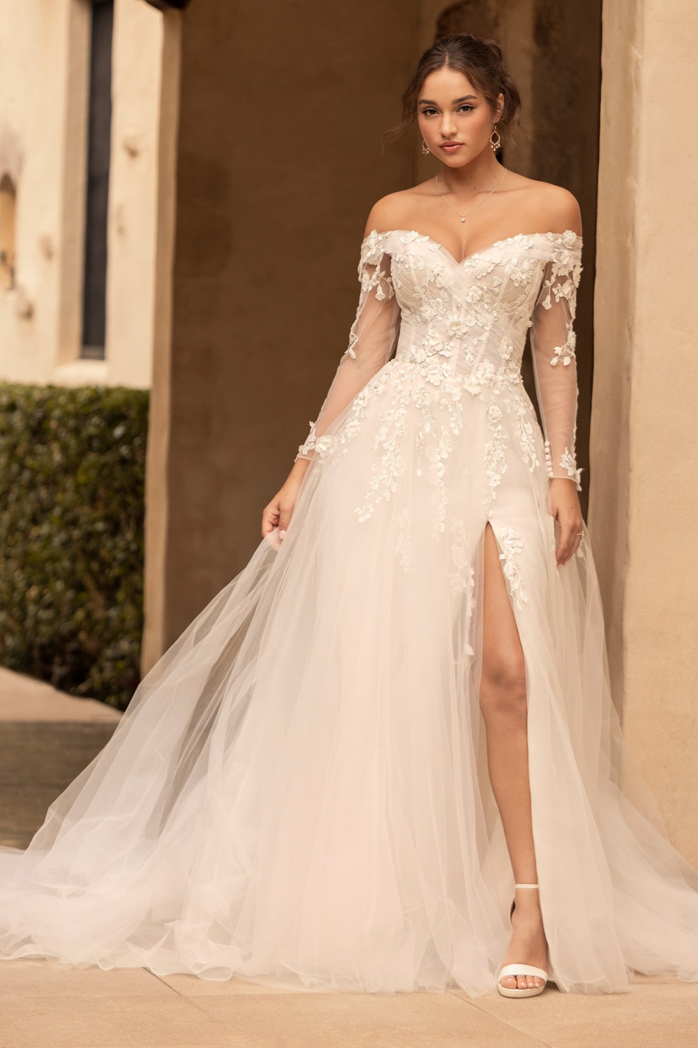 Ivory and blush off-the-shoulder lace fit-and-flare wedding gown
