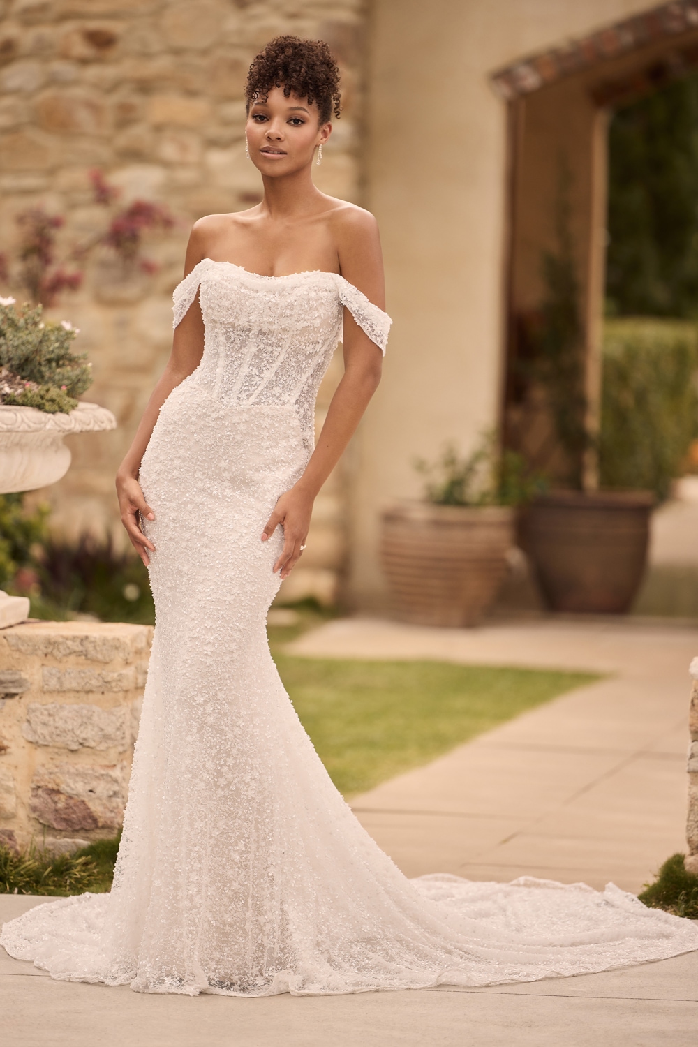 Ivory and blush beaded off-the-shoulder fit-and-flare wedding gown